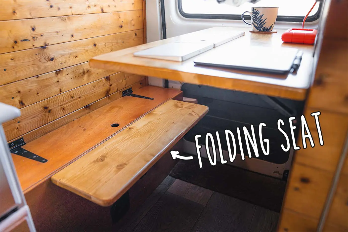 DIY van conversion office area showing fold up seating and desk