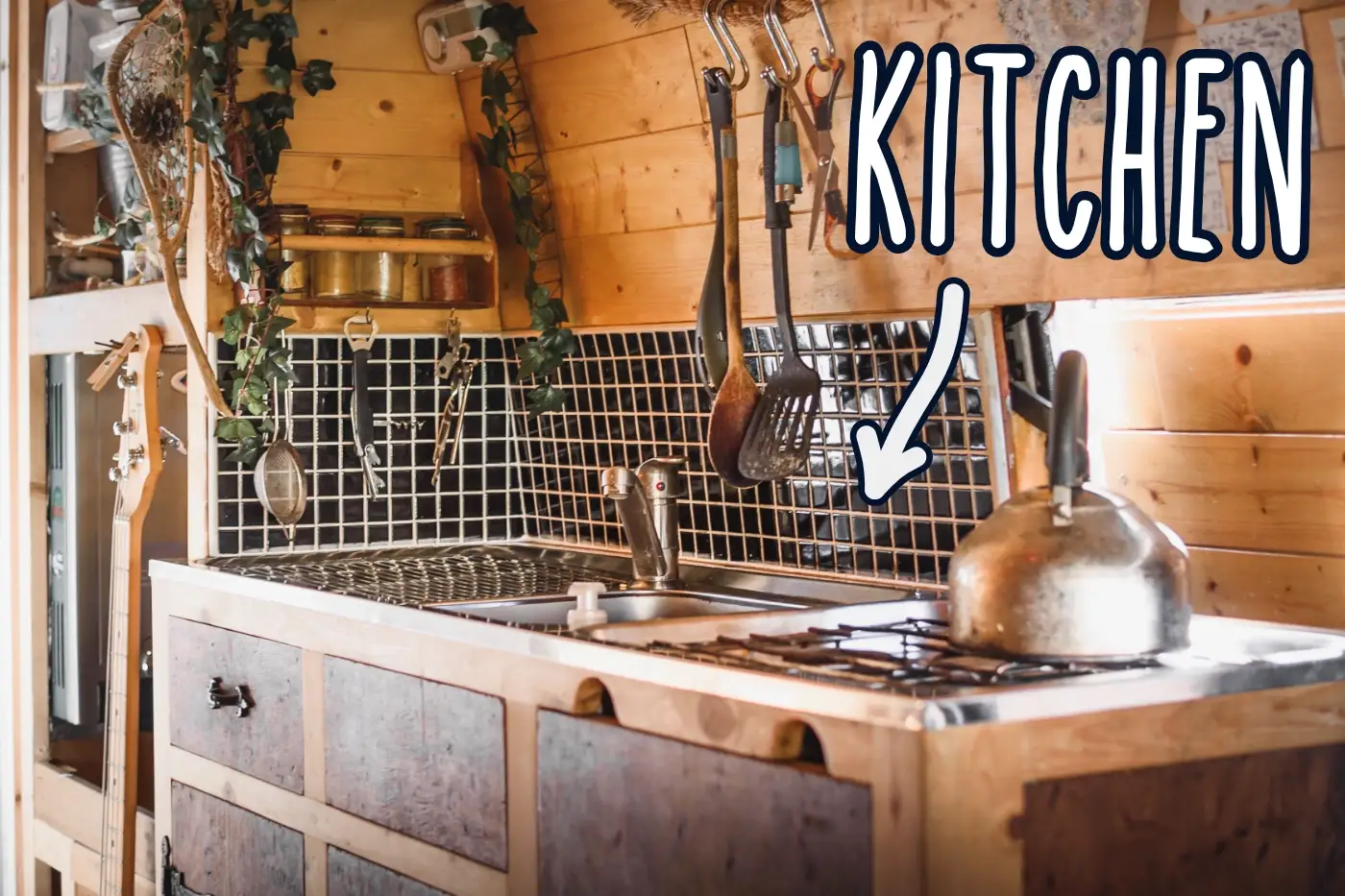 DIY campervan kitchen with sink and gas hob cooker and tiled splashback wall