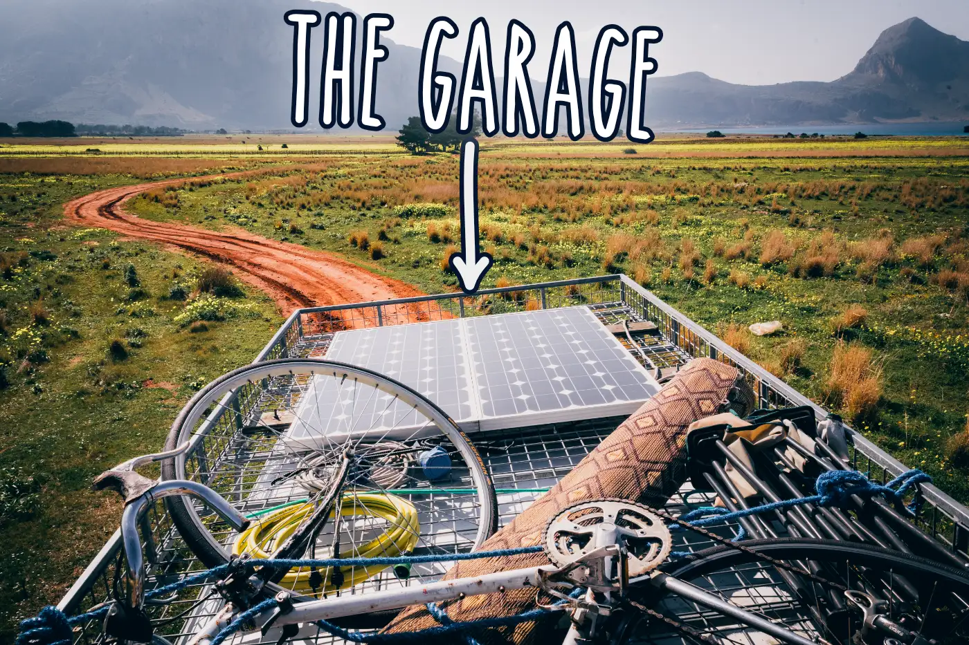 Roof rack on top of van showing solar panels and storage space for bike