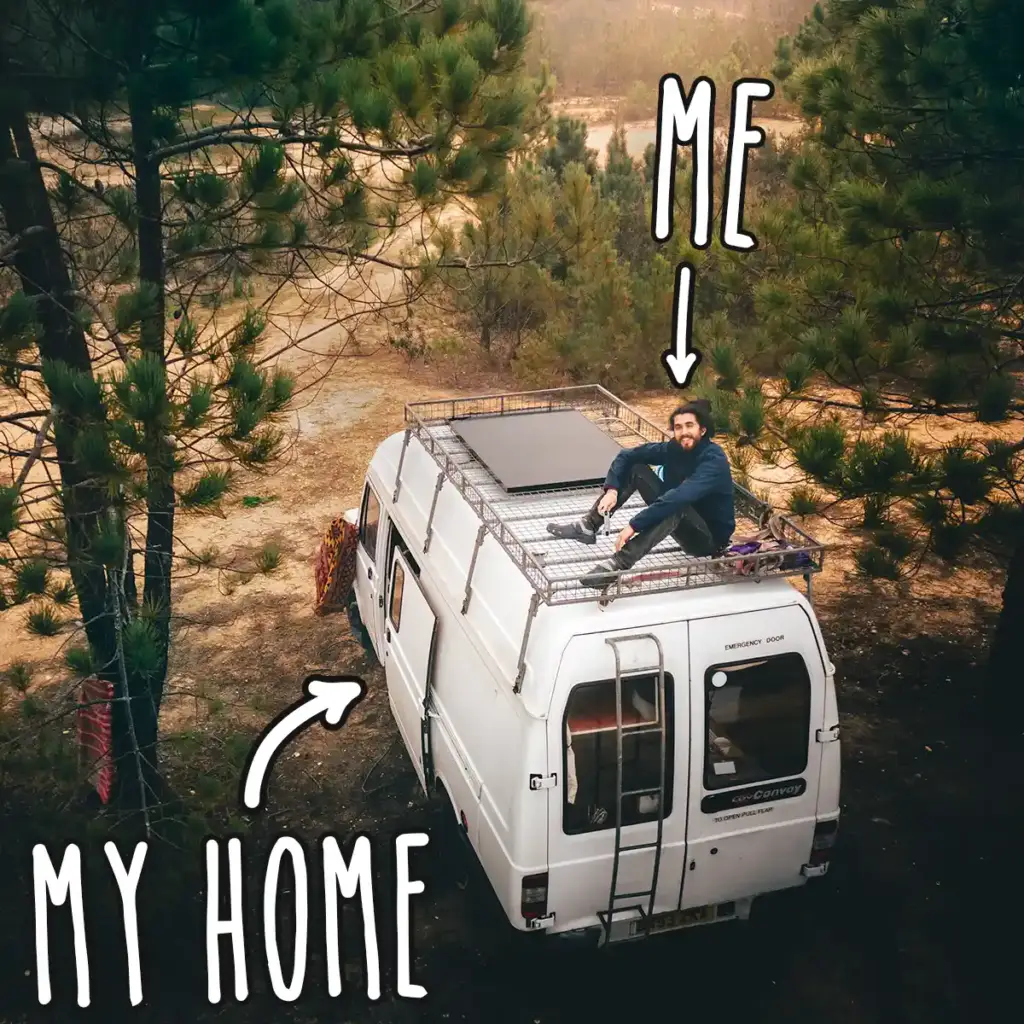 Mike Hudson sitting on top of his converted van — his home